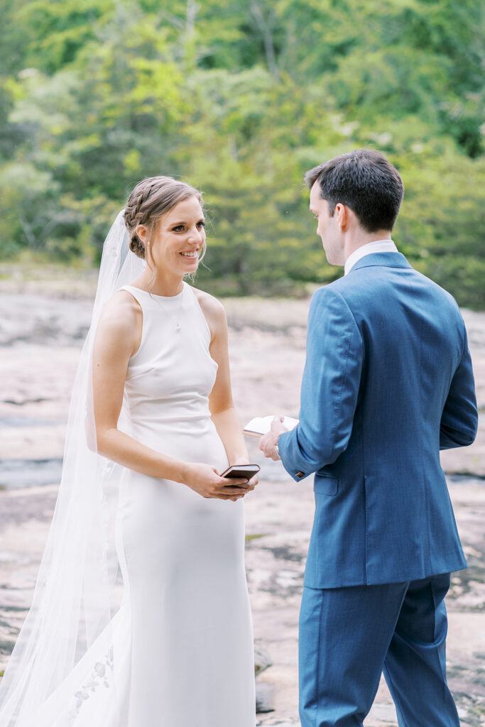 Bride smiles while sharing private vows alone with new husband