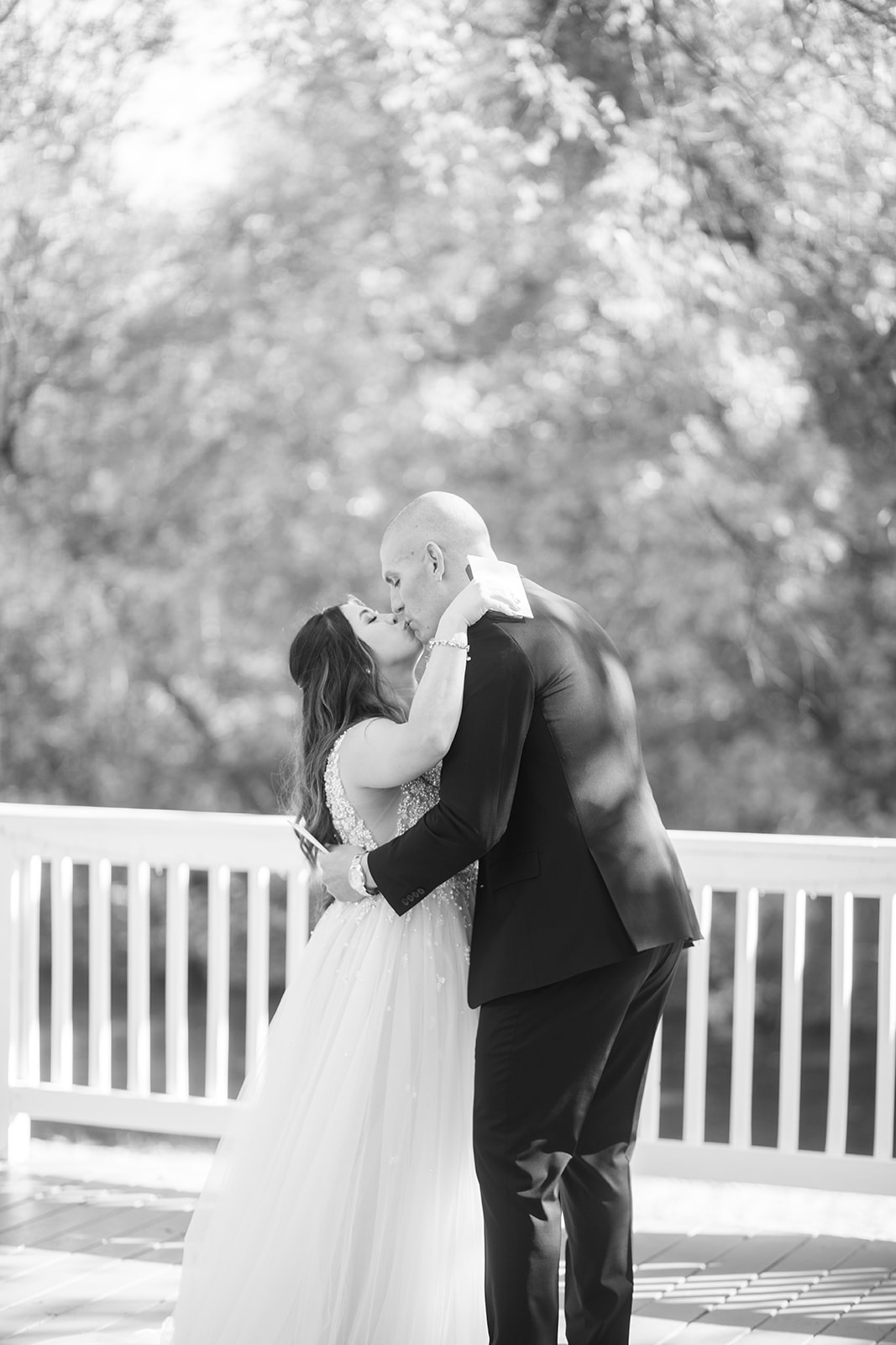 Bride and groom kiss during wedding first look