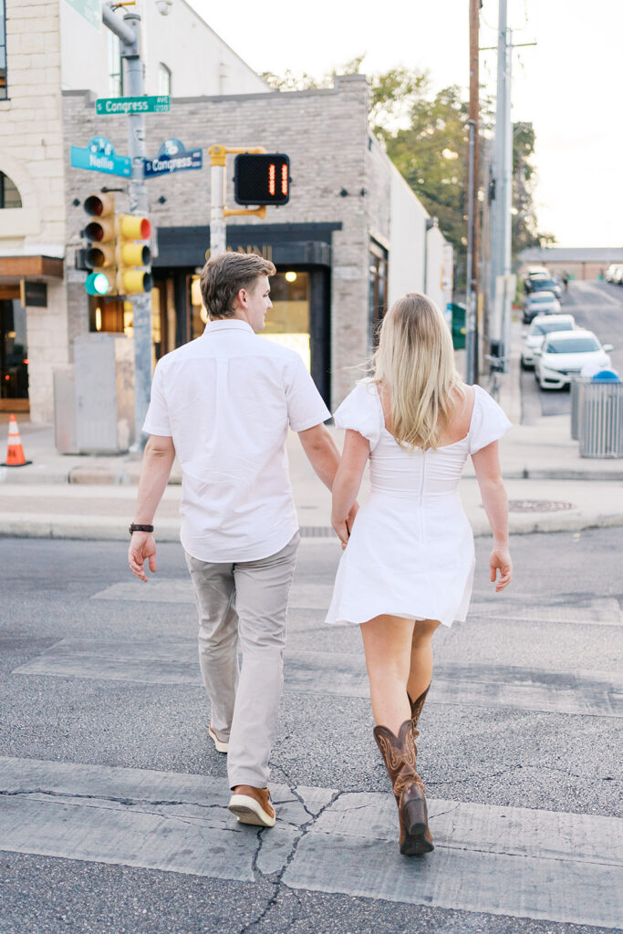 Couple crosses the street during their engagement session
